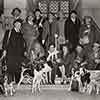 Standing are Dewey Robinson, Robert Greig, Robert Warwick, Arthur Stuart Hall, Torben Meyer, Jack Norton, Victor Potel, and Jimmy Conlin. Seated are Chester Conklin, Preston Surges, Claudette Colbert, Roscoe Ates, and William Demarest, The Palm Beach Story, 1942